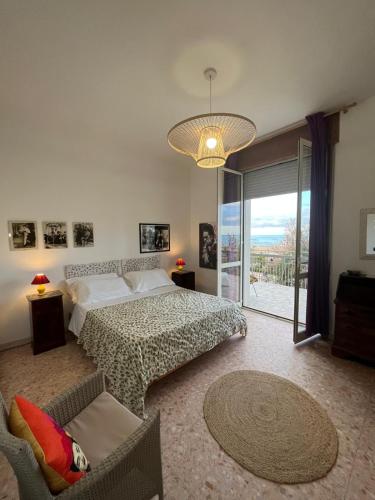 a bedroom with a bed and a large window at B&B Luci a'mmare in Roseto degli Abruzzi