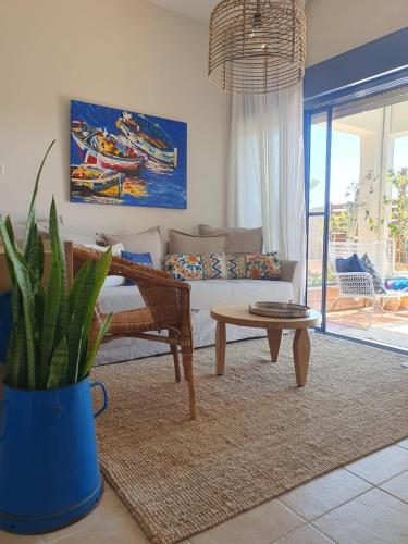 a living room with a couch and a table at The Turquoise Suite on the Sea Trail, Atlit in Atlit