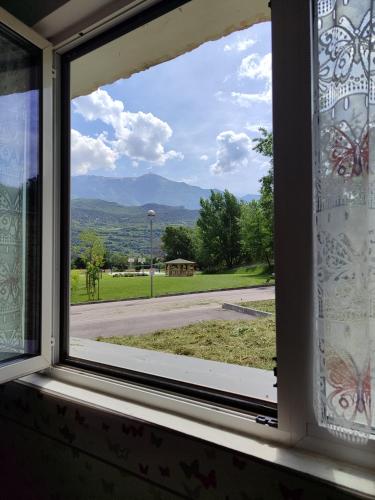 a window looking out at a view of a field at Al Nido in Pietramurata
