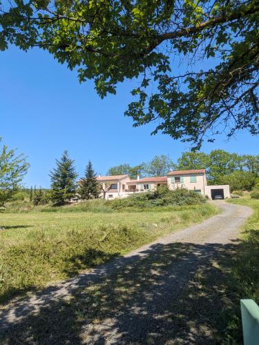 a house on a hill with a dirt road at Le Gîte de Berignac in Antugnac