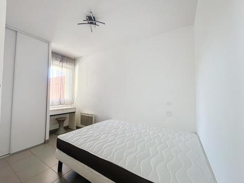 une chambre blanche avec un lit et une fenêtre dans l'établissement 3617-Appartement 4 couchages avec piscine, à Argelès-sur-Mer