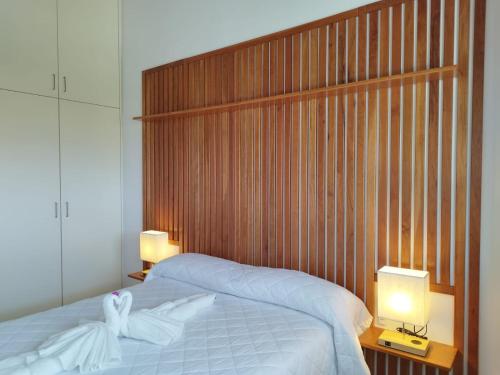 a bedroom with a bed with a wooden headboard at Smile Seaview in Nerja