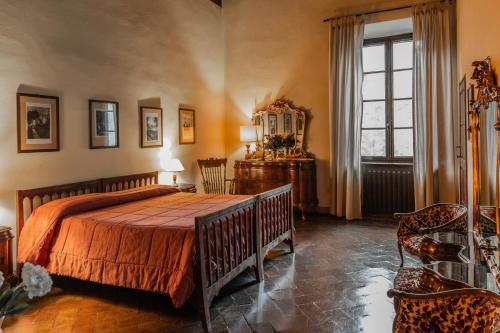 a bedroom with a bed and a table and a window at Villa Rucellai in Prato