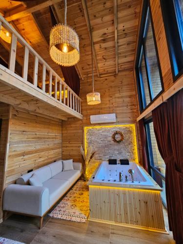 a living room with a couch and a tub at Heyamoo Tatil Köyü in Çamlıhemşin