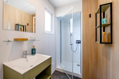 une salle de bain avec un lavabo et une douche dans l'établissement Camping Domaine Les Carrelets de Soulac - Maeva Sélection, à Soulac-sur-Mer