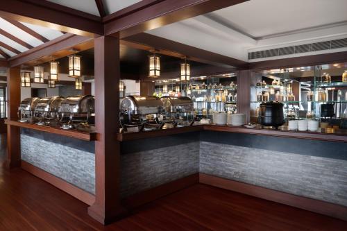 a bar with several pots and pans on a brick wall at Presidency Towers,Kochi in Cochin