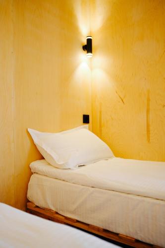 a bedroom with two beds and a light on the wall at Panorama Glamping in Saty