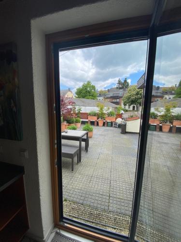 a view of a patio through a sliding glass door at Ferienwohnung Lodge 43 in Trier