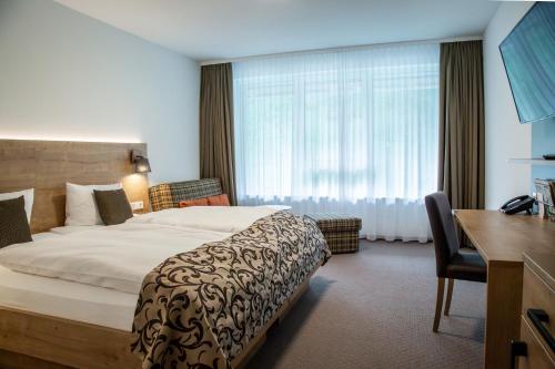 En eller flere senge i et værelse på Hotel Hofgut Sternen