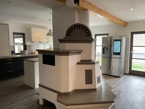 a kitchen with a stove and a refrigerator at Spessart Oase in Marktheidenfeld