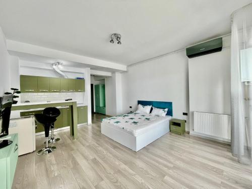 a white bedroom with a bed and a desk at Sea and lake view- Casa del Mar in Mamaia Nord