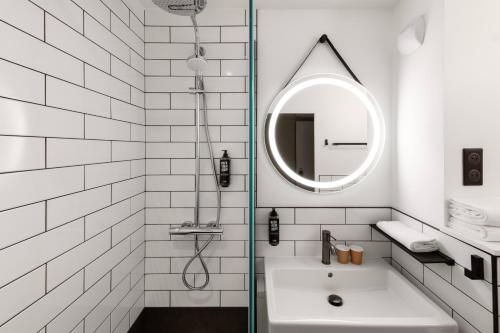 a white bathroom with a sink and a mirror at ibis La Baule Pornichet Plage in Pornichet