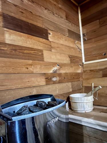 a trash can sitting next to a wooden wall at Hotel Transalpin in Obarsia-Lotrului