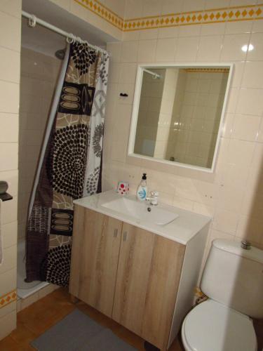 a bathroom with a sink and a toilet and a mirror at Pueblo Mar - Guadalmar in Málaga