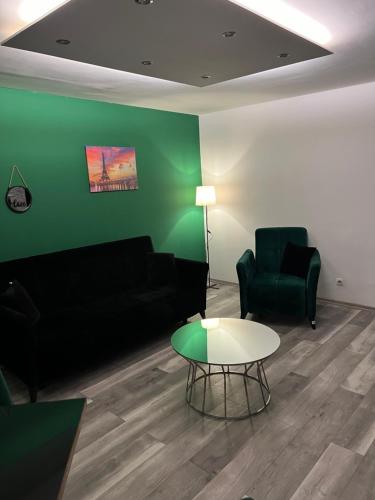 a living room with a couch and a table at Apartman OMAR stan na dan besplatan parking Sarajevo in Sarajevo