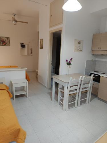 a kitchen and living room with a table and chairs at Maria's Apartments in Kalyves