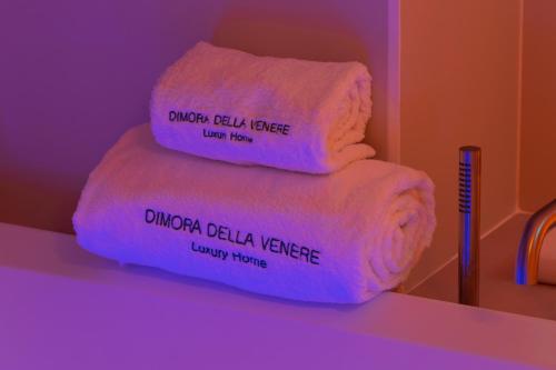 a stack of towels with words written on them at Dimora della Vener Luxury Home in Vieste