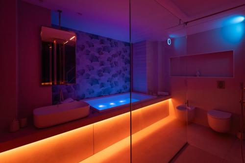 a purple bathroom with a tub and a shower at Dimora della Vener Luxury Home in Vieste