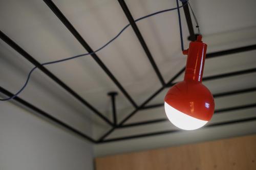 a red light bulb hanging from a ceiling at Hobo Hotel Stockholm in Stockholm