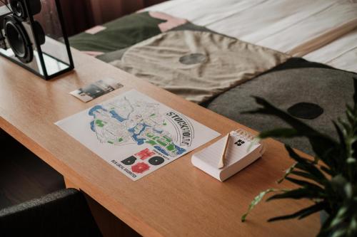a table with a book and a map on it at Hobo Hotel Stockholm in Stockholm