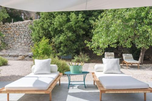 two beds sitting on a patio with a table at Amani Luxury 4-Bedroom Villa & Pool in Batroun in Batroûn