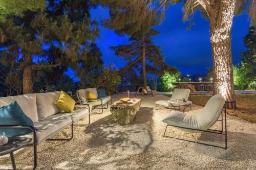 a group of chairs and a couch and a table at Amani Luxury 4-Bedroom Villa & Pool in Batroun in Batroûn