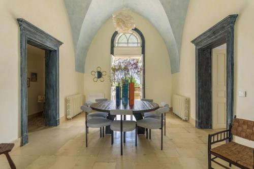 a dining room with a table and chairs and a window at Amani Luxury 4-Bedroom Villa & Pool in Batroun in Batroûn