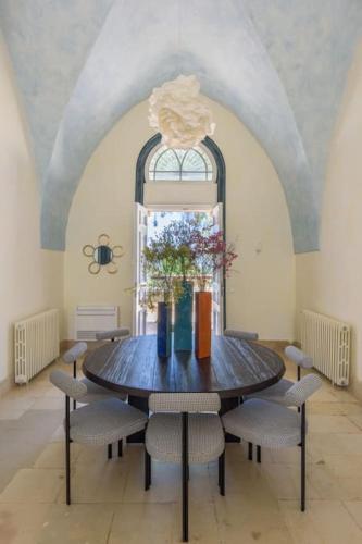 a dining room with a wooden table and chairs at Amani Luxury 4-Bedroom Villa & Pool in Batroun in Batroûn