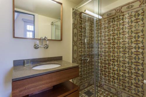 a bathroom with a sink and a glass shower at Amani Luxury 4-Bedroom Villa & Pool in Batroun in Batroûn