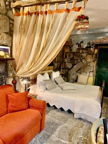 a bedroom with a bed and a couch at L'Antico Loco Commodo in Viterbo