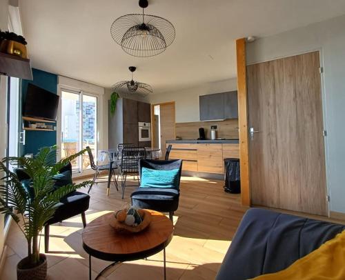 a living room with a couch and a table at Appartement LES PIEDS DANS L'EAU in Saint-Gilles-Croix-de-Vie