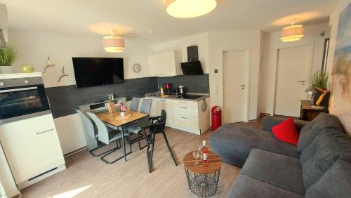 a living room with a couch and a table at Ferienwohnung Ostsee Graal-Müritz Küstenwald in Gelbensande