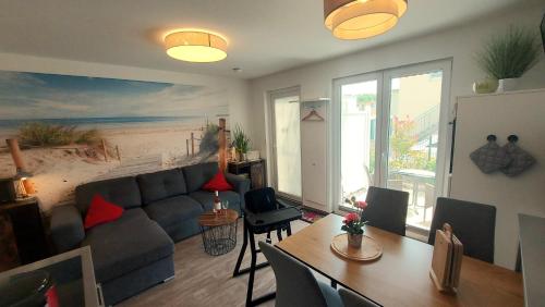 a living room with a couch and a table at Ferienwohnung Ostsee Graal-Müritz Küstenwald in Gelbensande