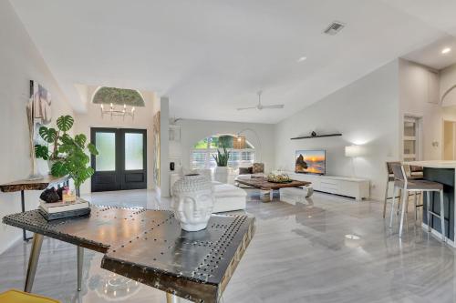 a living room with a couch and a table at Privacy Pool Gulf Access and Luxury in Bonita Springs