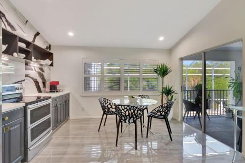 a kitchen with a table and chairs in a room at Privacy Pool Gulf Access and Luxury in Bonita Springs
