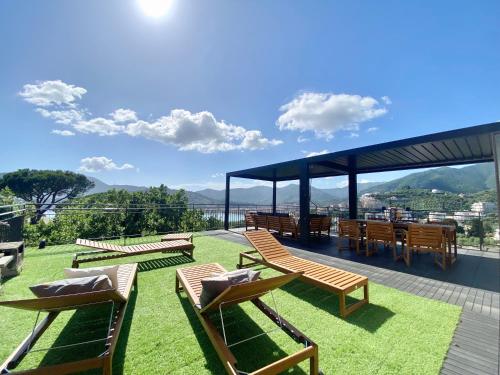 a group of chairs and tables on a roof at CasaViva - Terrace Apt with Parking in Rapallo in Rapallo