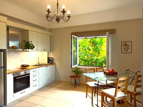 a kitchen with a table and a dining room at Endless Green 4 Arethousa Ikaria in Arethousa