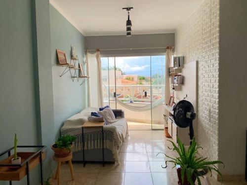 a bedroom with a bed and a sliding glass door at Apartamento Xodó - completo - 102 country club Juazeiro in Juazeiro