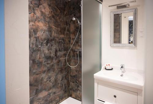 uma casa de banho com um chuveiro e um lavatório. em Bed & Breakfast Goldener Stiefel em Mariazell