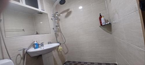a white bathroom with a sink and a shower at tree house in Jeju