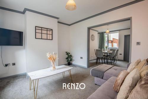 a living room with a couch and a table at Bright and Warm Home in Lincoln by Renzo, Free Wi-Fi, Perfect for Staycations! in Lincolnshire
