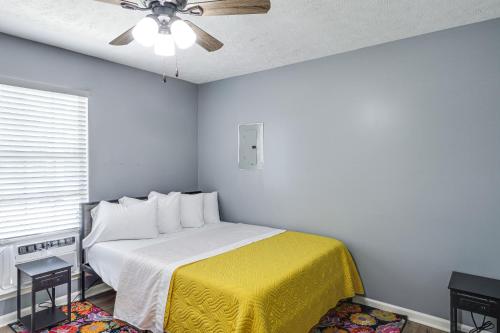 a bedroom with a bed with a yellow blanket and a ceiling at Murfreesboro Family Home with Pool and Backyard! in Murfreesboro