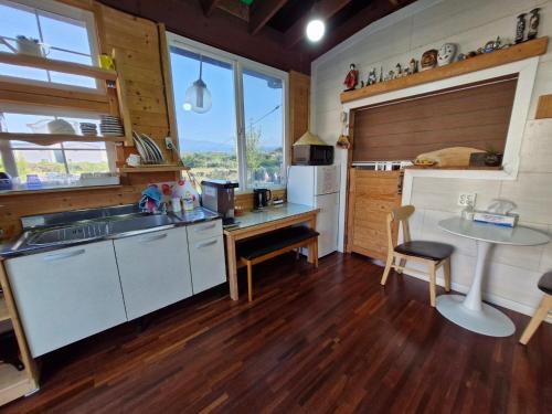 a kitchen with a sink and a table at tree house in Jeju