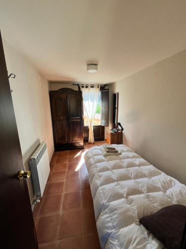 a bedroom with a large bed and a window at CabraBerry in Cabra de Mora