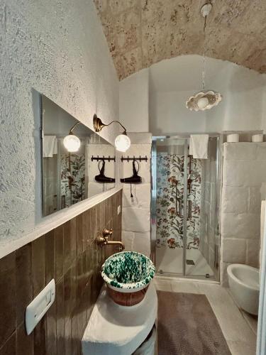 a bathroom with a sink and a shower at La Vitagira in Monopoli