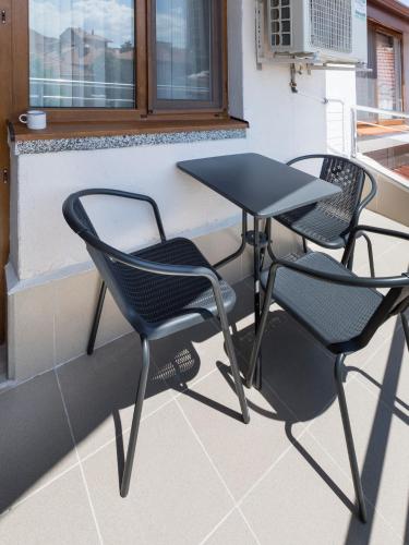two chairs and a table on a balcony at Home Gramatikovi in Pomorie