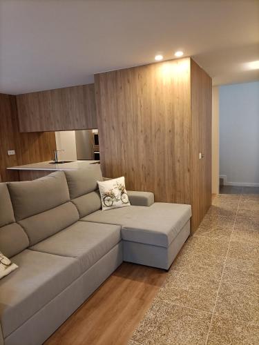 a living room with a couch and a kitchen at AL Fonte de S Tiago in Fafião