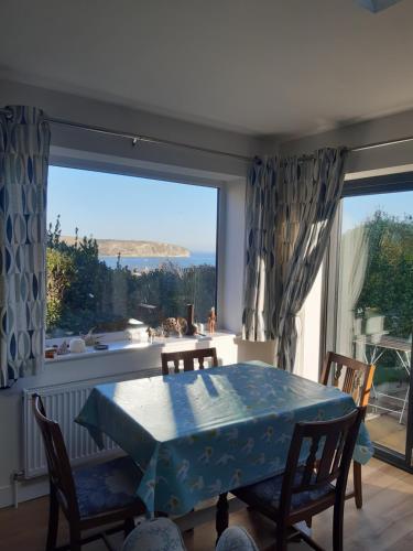 a dining room with a table and a large window at Marlow in Swanage