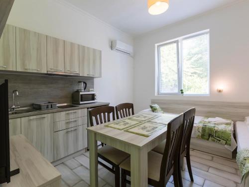 a kitchen and dining room with a table and chairs at Home Gramatikovi in Pomorie