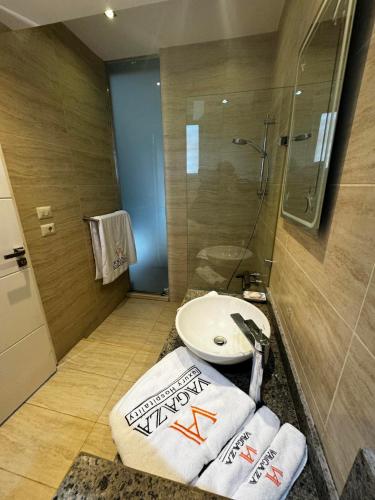 a bathroom with a toilet and a shower and towels at Deluxe Cabana with Vagaza signature in Hacienda Bay North Coast in El Alamein